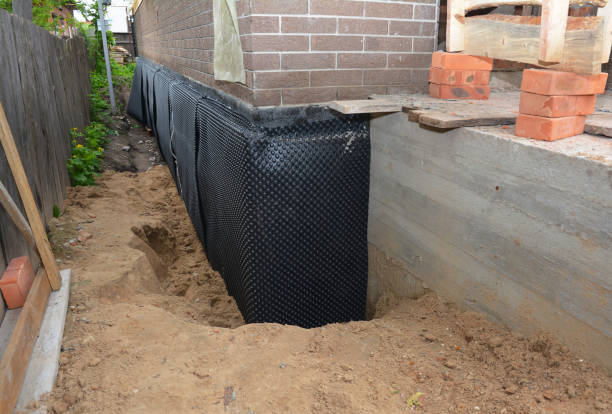 SJ Waterproofing Pros technician performing targeted Basement Waterproofing assessment in Amityville, NY